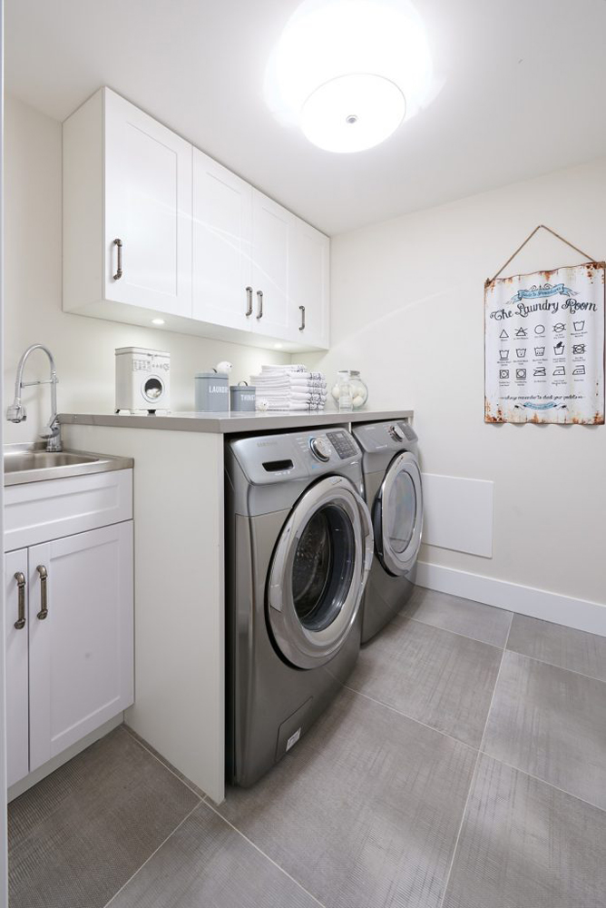 White laundry room with grey washer and dryer