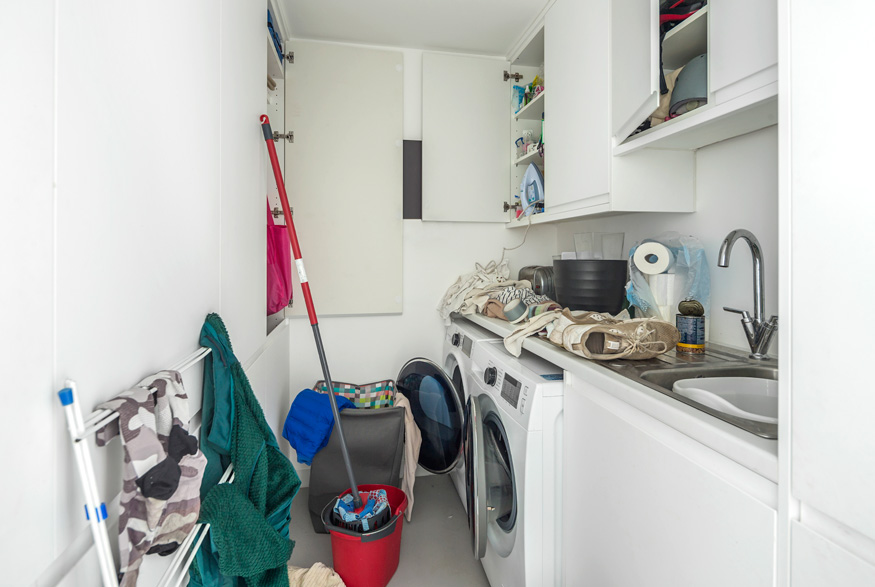 Stuff cluttering a laundry room