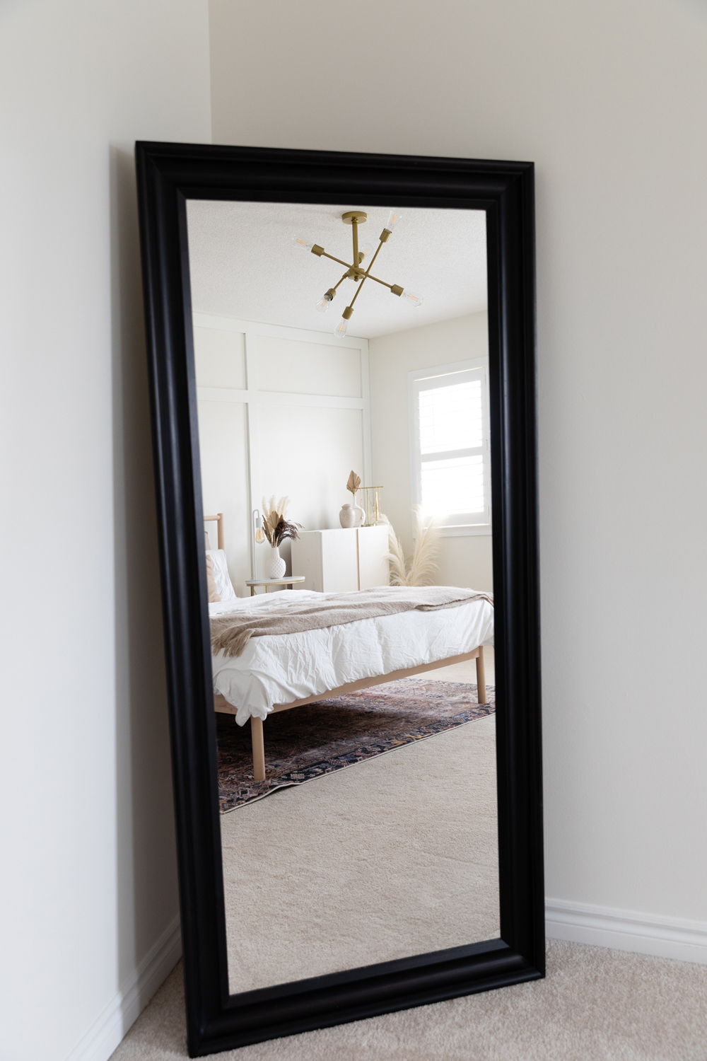 Lauren Sheriff home tour showing leaning mirror in bedroom