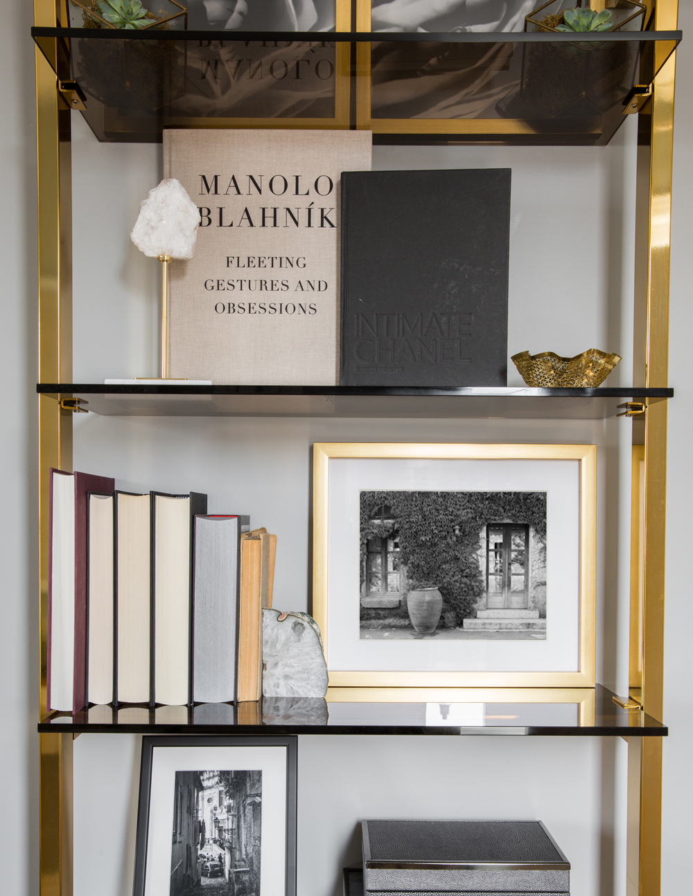 brass frame book shelf with smoked glass shelves, photos, fashion books