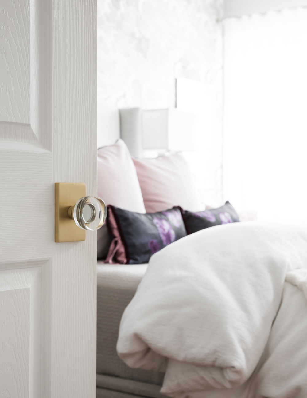 Door with clear knob and brass plate opening to bedroom