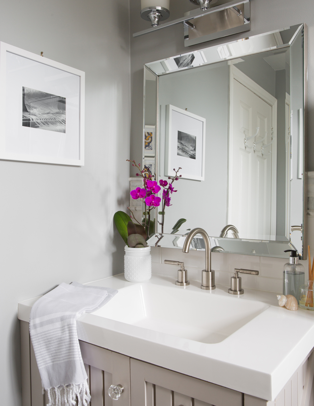 bathroom vanity with bevelled mirror, fuchsia orchid, black and white pic in white mat and frame