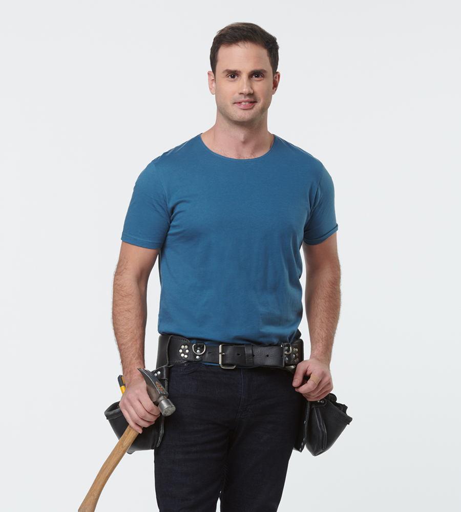 Sebastian Sevallo standing with a full tool belt and dashing smile