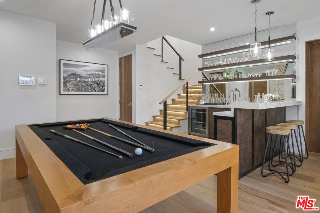 Game room with pool table and bar