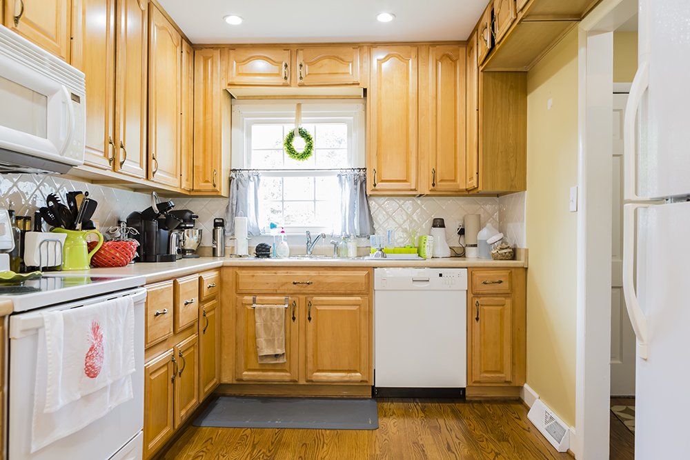 A dated kitchen with wood cabinetry