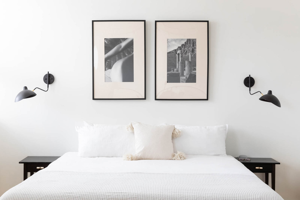 Two framed photos above the master bed