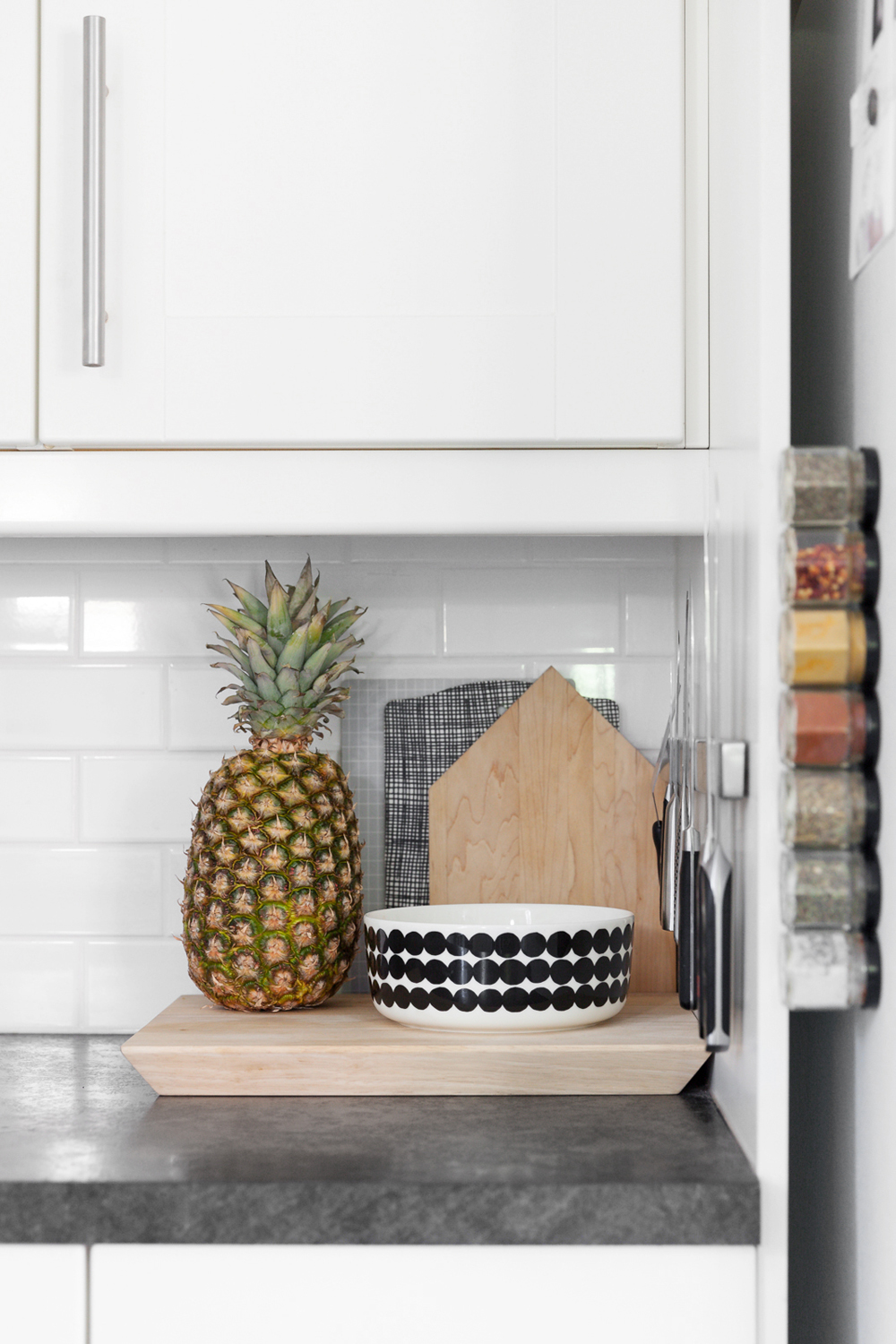 A patterned bowl and fresh pineapple on the kitchen counter