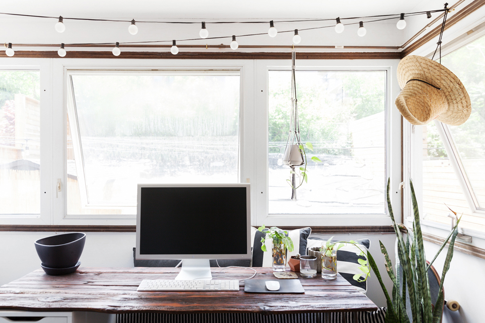 Home office with plants and wood desk