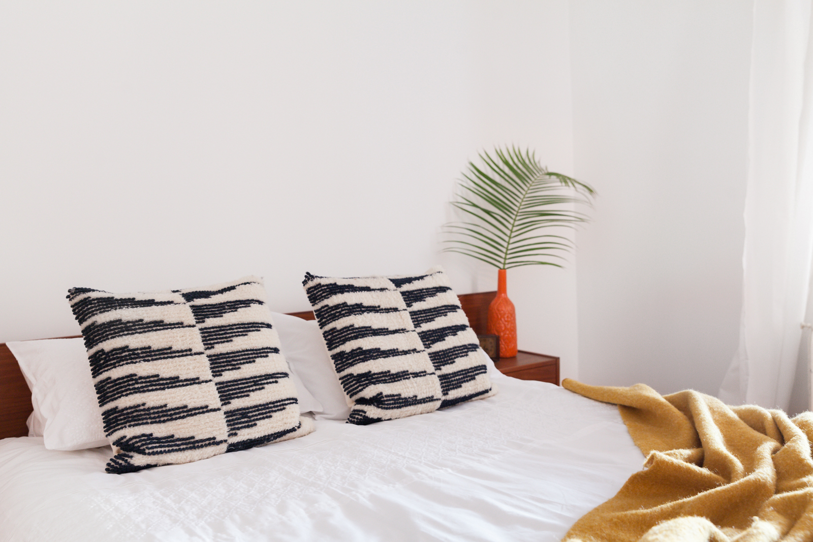 black-and-white throw pillows on bed