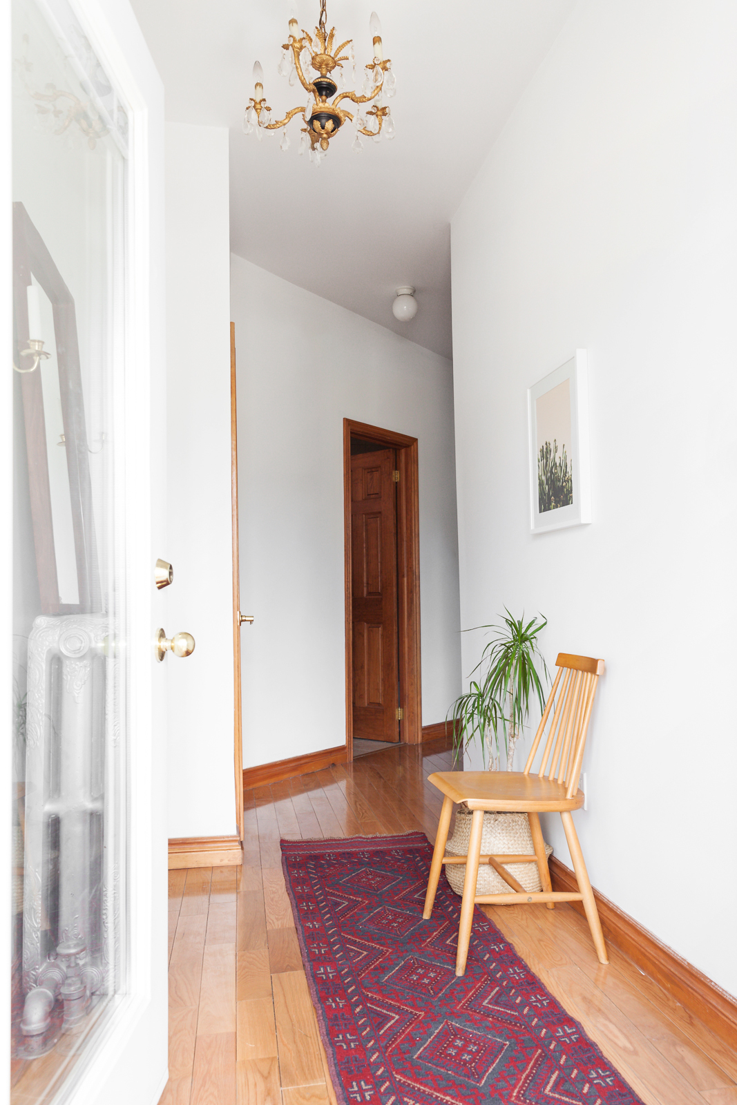 front hall with geometric runner and spindle chair