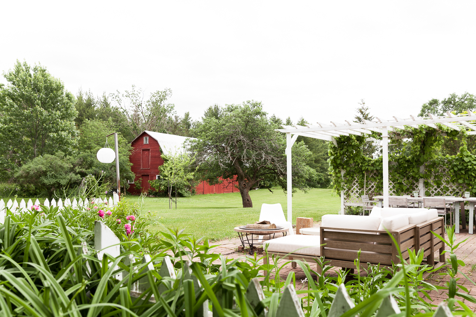 Backyard of rental property in Prince Edward County with a red barn and patio.