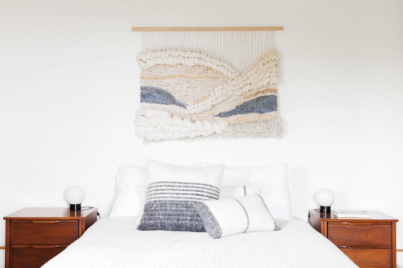 Macrame art wall hanging over bed