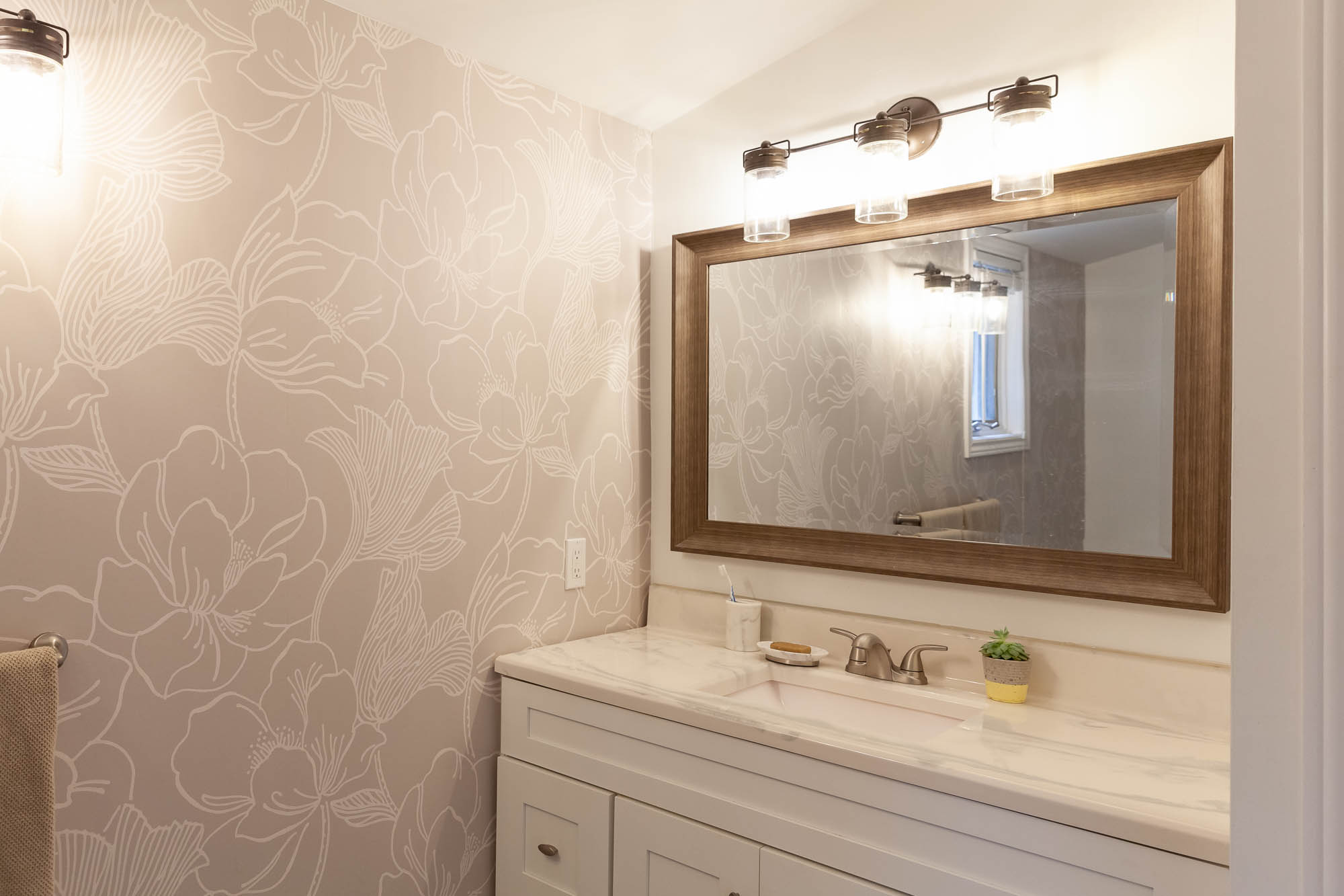 modern renovated bathroom with floral wallpaper accent wall