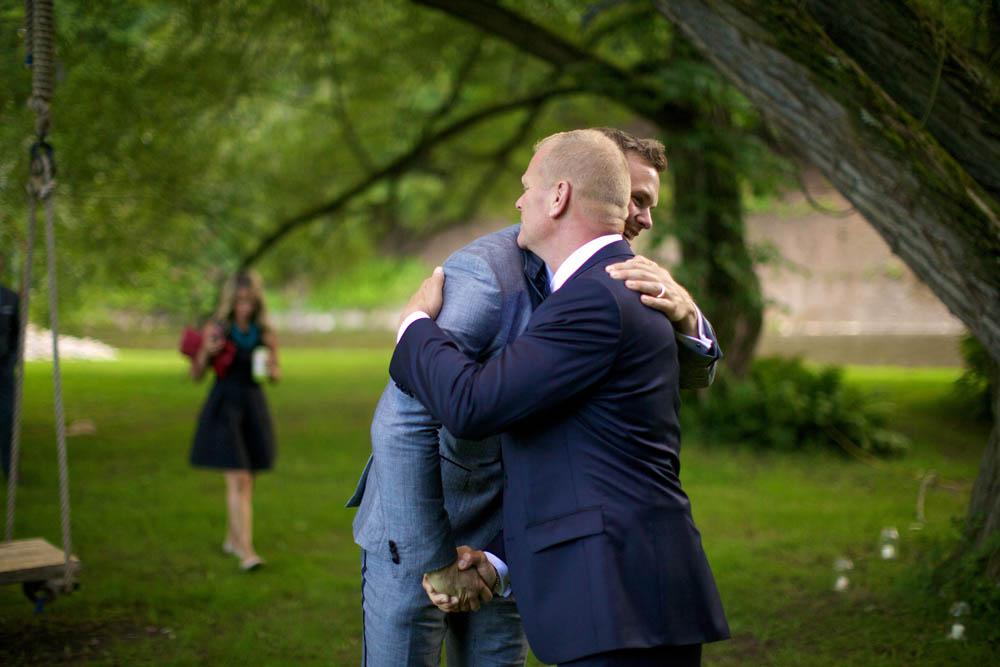 Mike Holmes and Mike Holmes Jr. hug on Mike Holmes Jr.'s wedding day