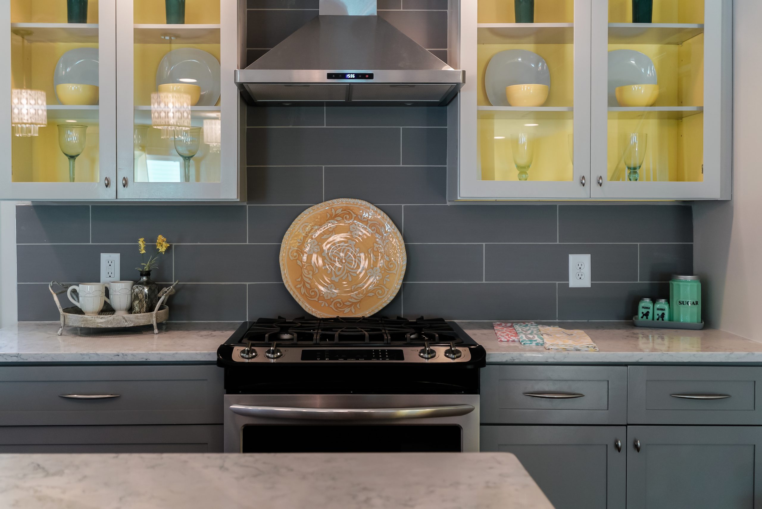 Grey kitchen design with hits of yellow.