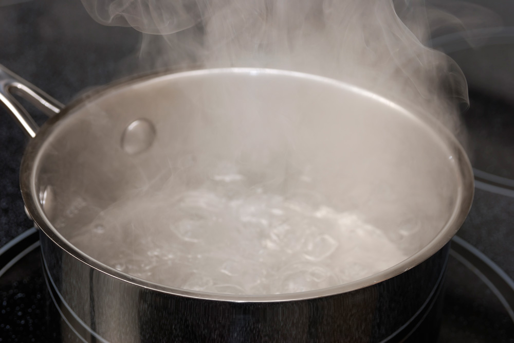 Steam rising from a pot of boiling water