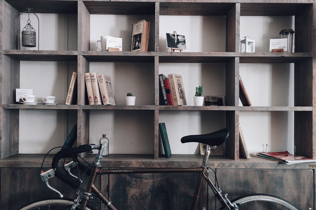 An organized wooden shelf with a bicycle