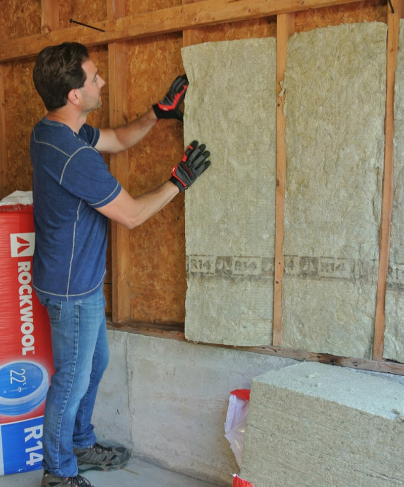 Scott McGillivray installs insulation during a home renovation