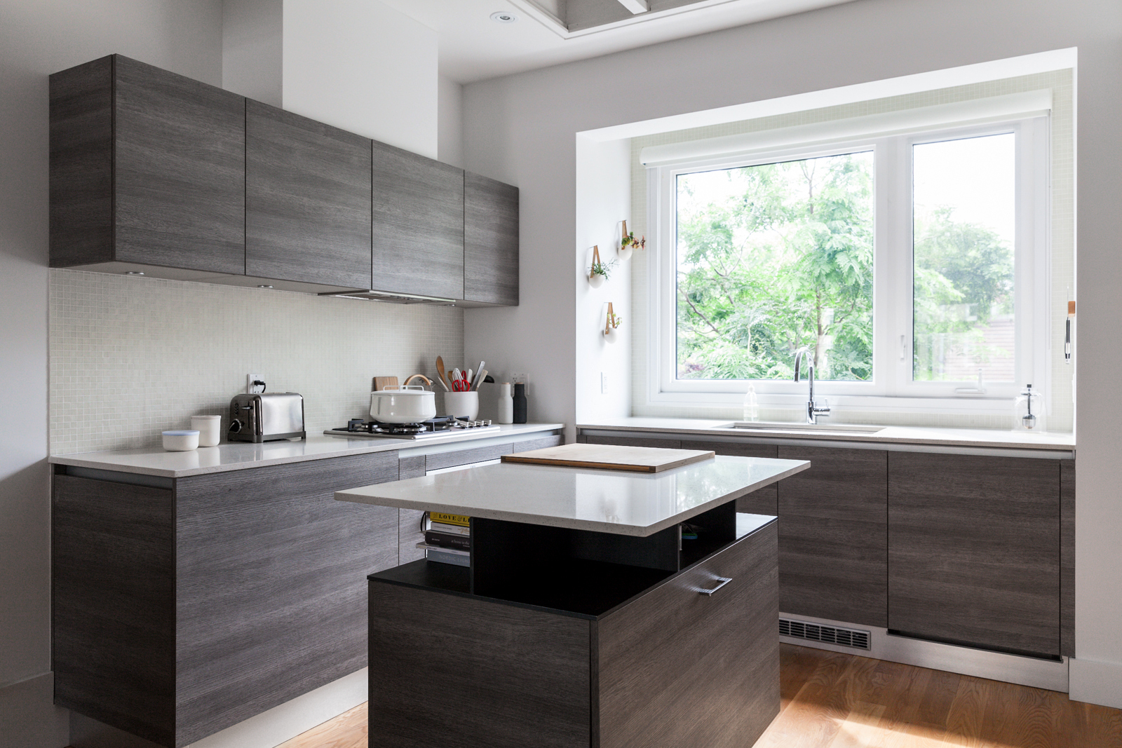 Modern minimalist kitchen design with dark-stained wood cabinetry.