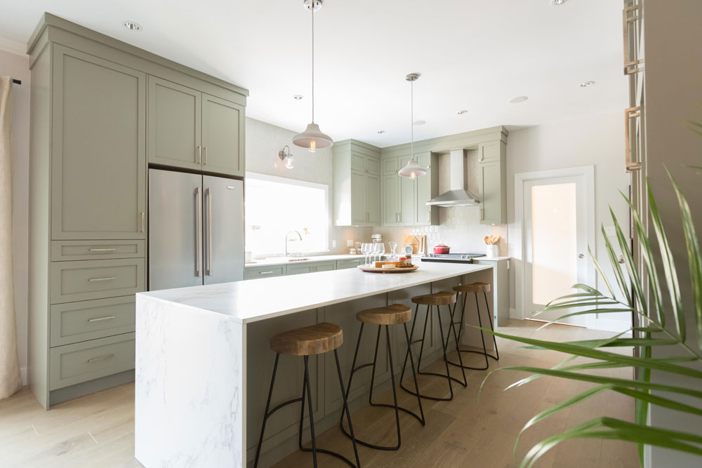 Refined farmhouse kitchen with soothing pale green palette.