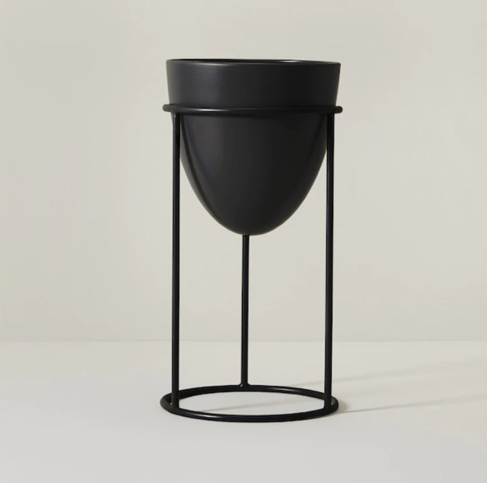 Black cone shaped planter resting on a stand