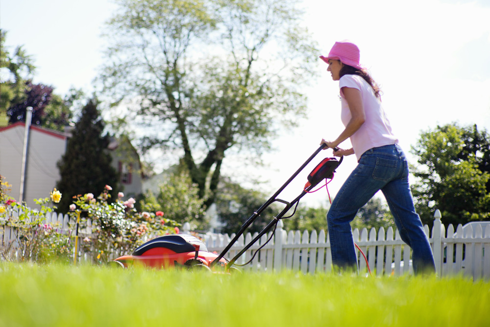 Woman mowing the yard