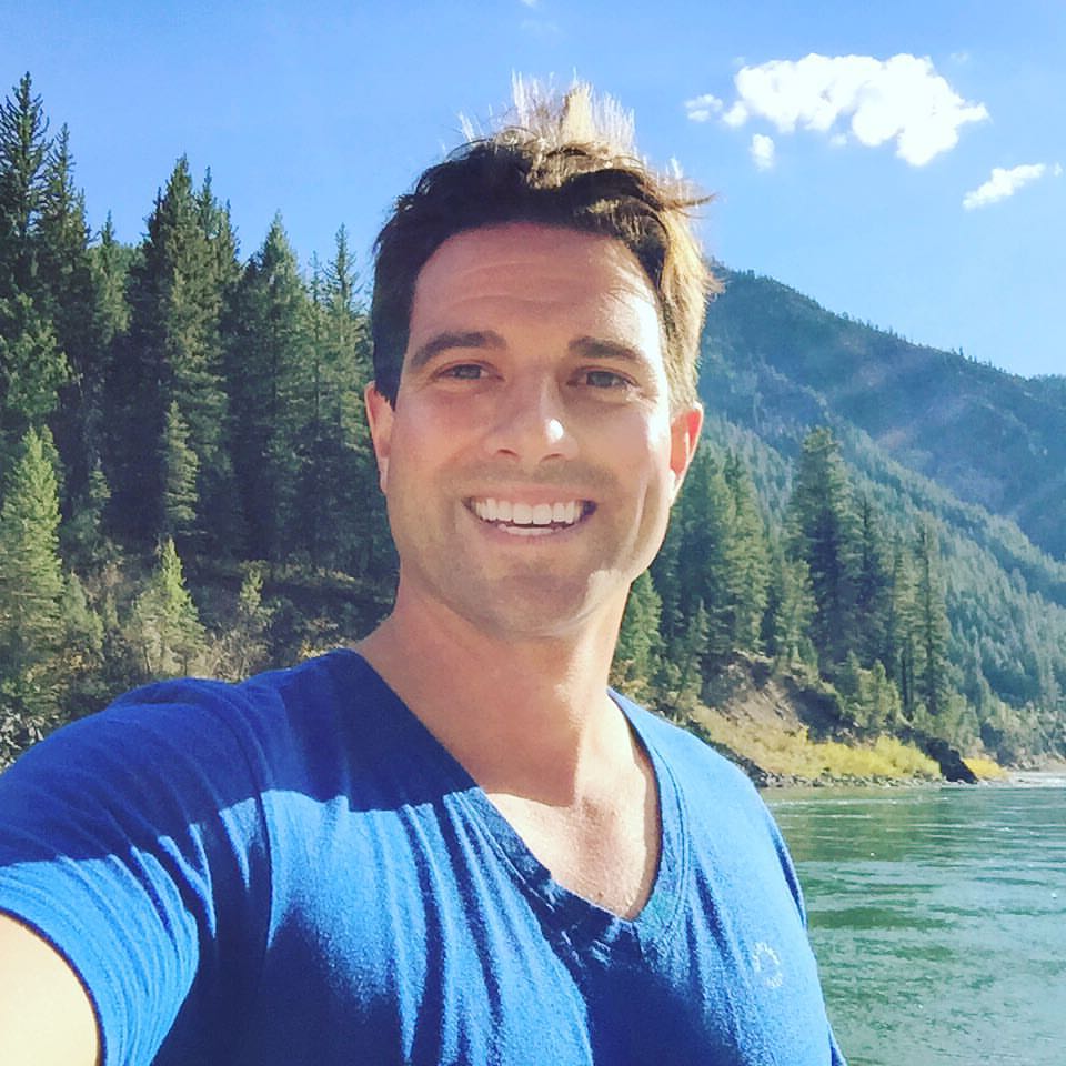Scott McGillivray posing in front of mountains