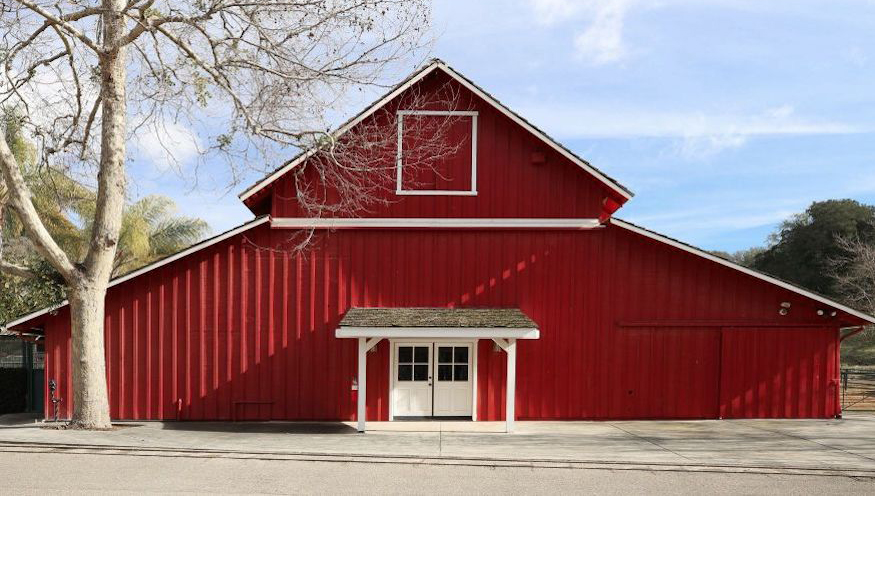A large red barn with white trim