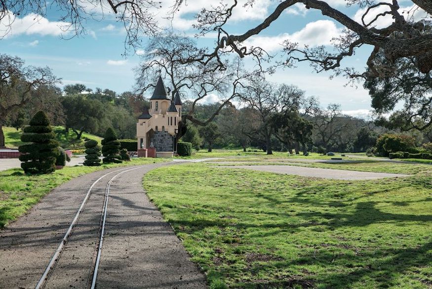 A railroad track leading up to a tiny castle, one of many that dot the property