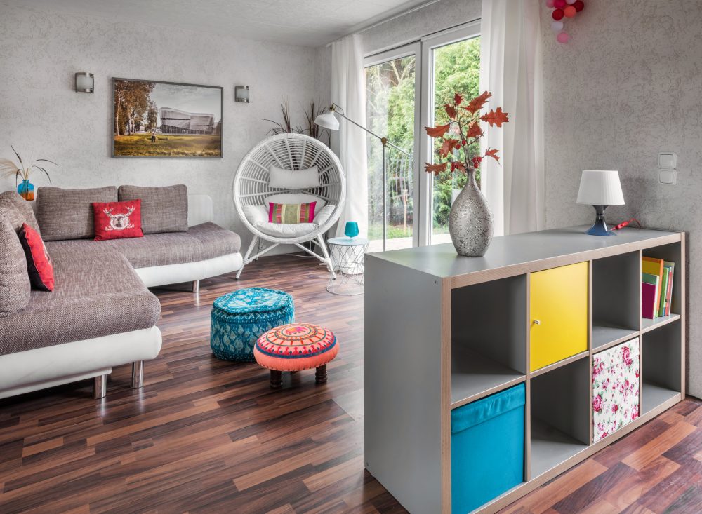 grey shelving unit with colourful boxes in open-concept living room