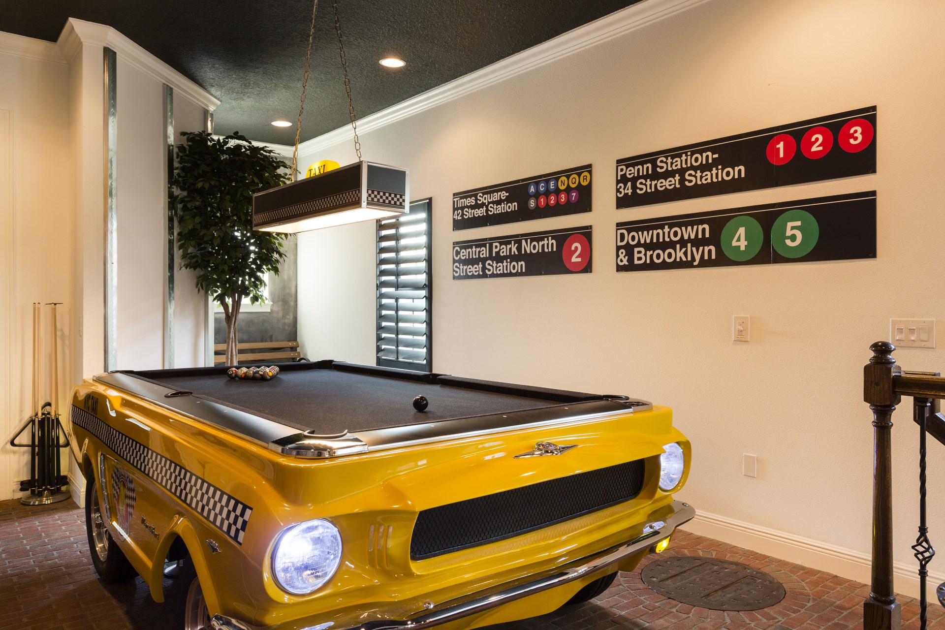 A New York City-inspired games room with vintage subway signs and widescreen TV