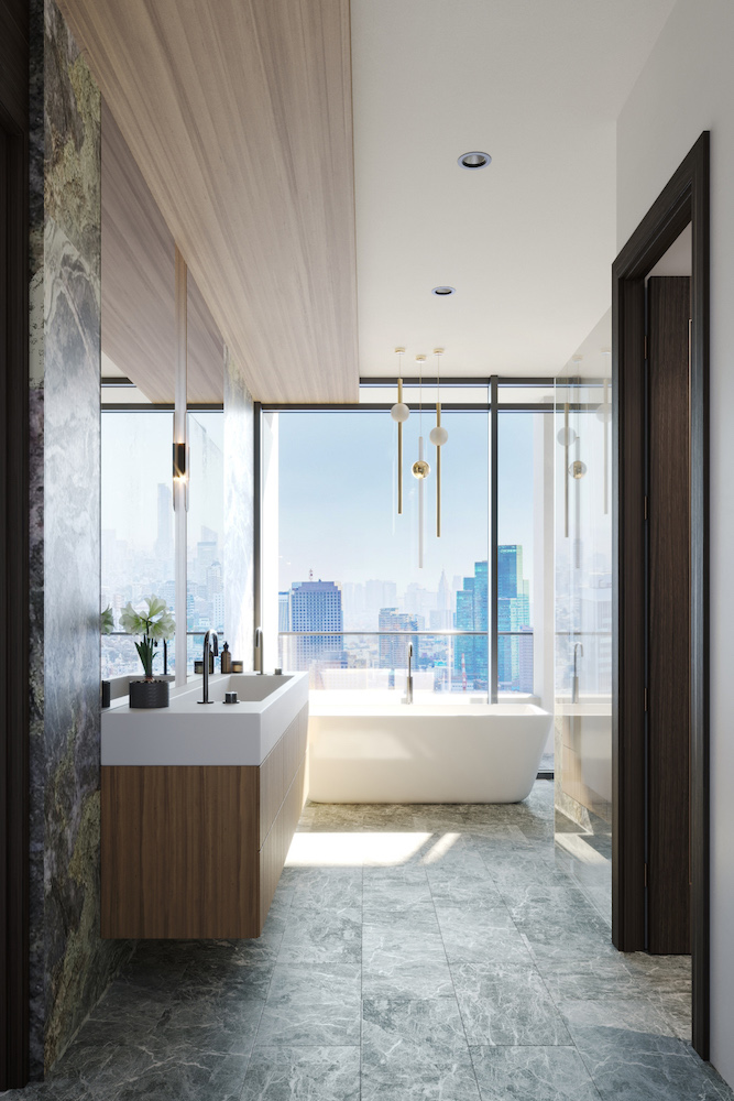 bathroom of penthouse suite with floating vanity and standalone bathtub with view of city through window