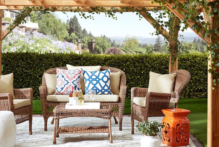 Colourful pillows on wicker patio furniture