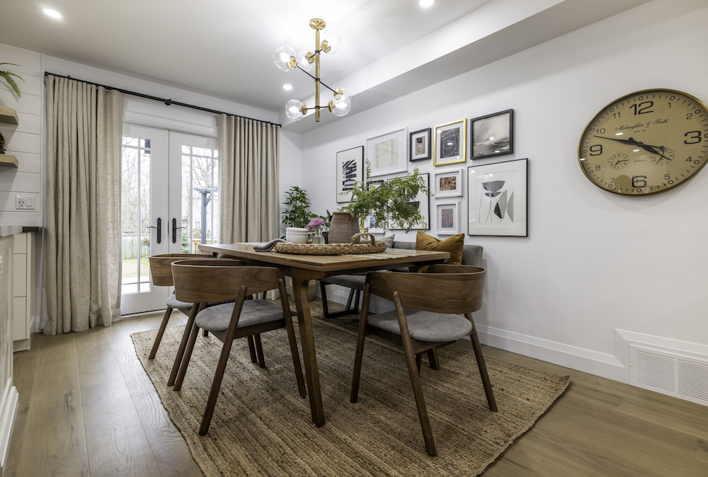 white family dining room with gallery wall and wood dining table