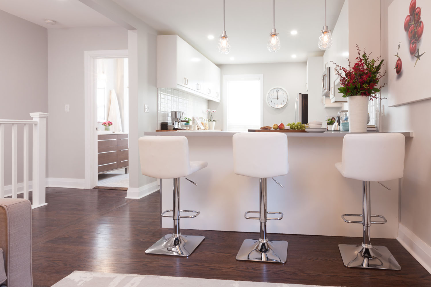 Modern kitchen counter with white bar stools