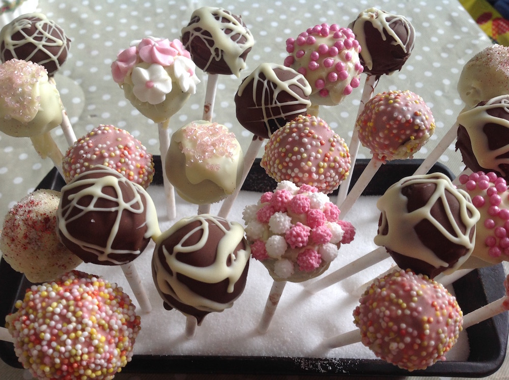 pink, white and brown cake pops on polka-dot background