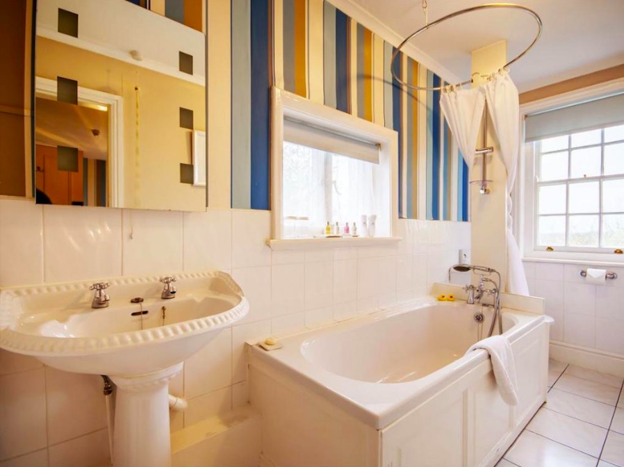 Pristine white bathroom with deep soaking bathtub