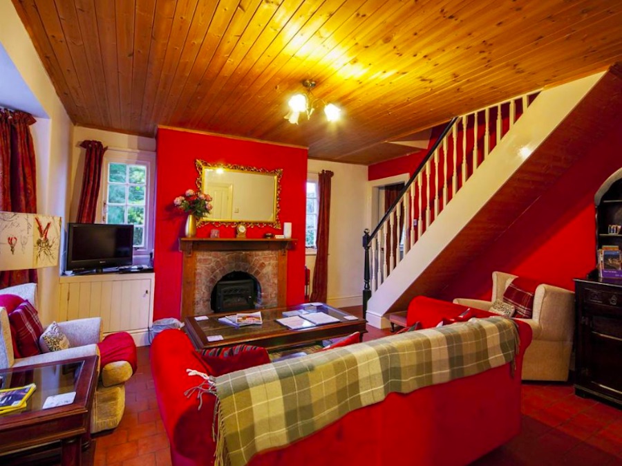 The red-themed ground-floor living room of the lodge