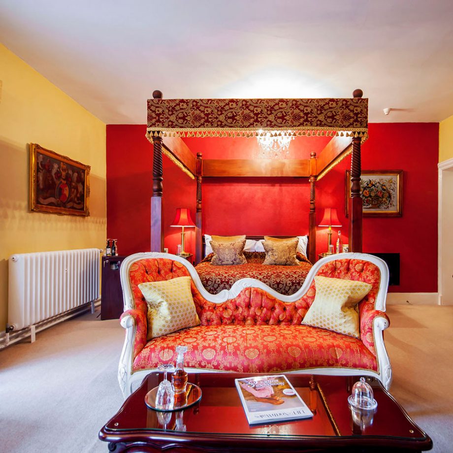 A bright red bedroom with matching furniture and mahogany coffee table