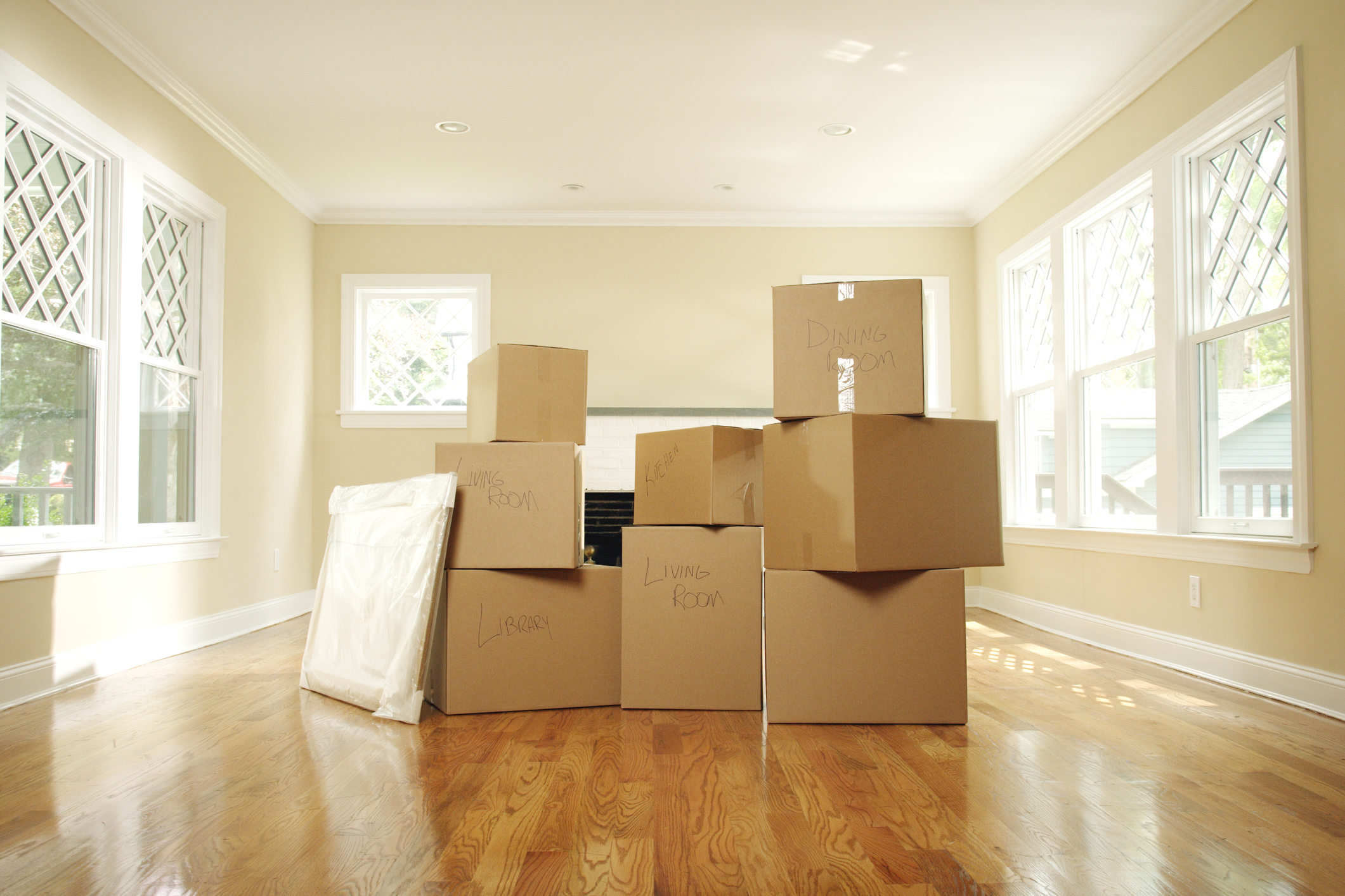 Packing boxes stacked in empty living room