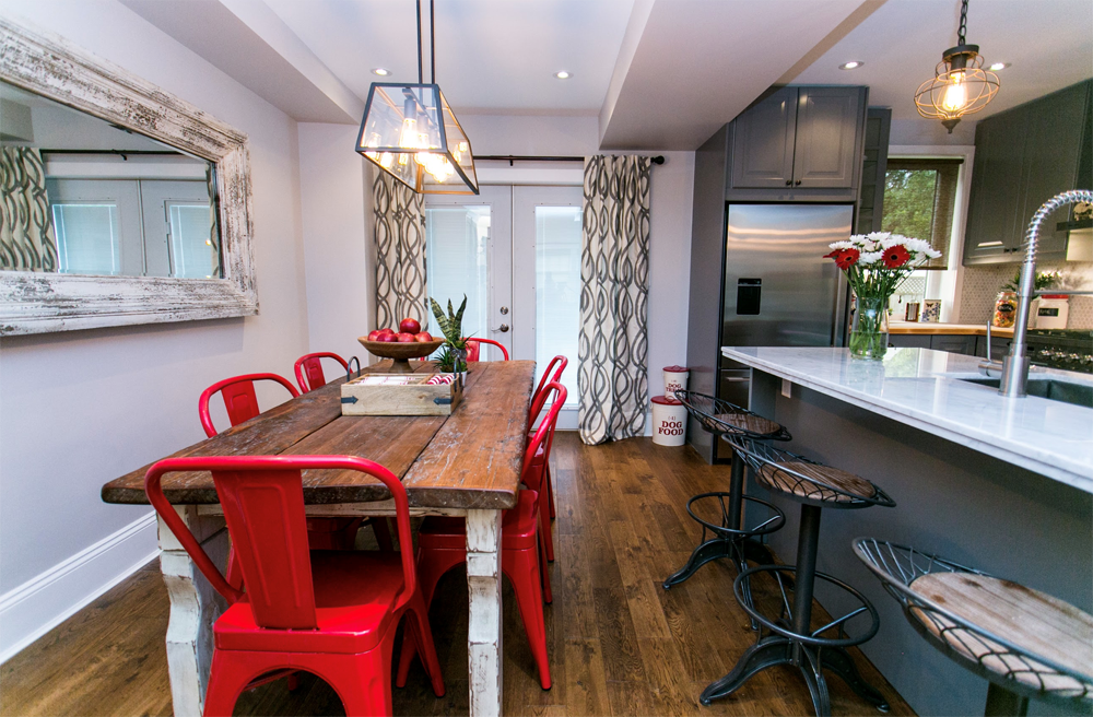 Kitchen with farmhouse table and red chairs