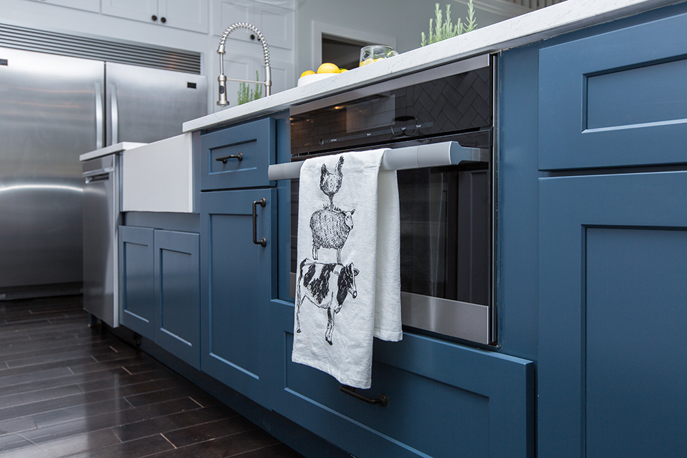Blue cabinetry with black and chrome hardware