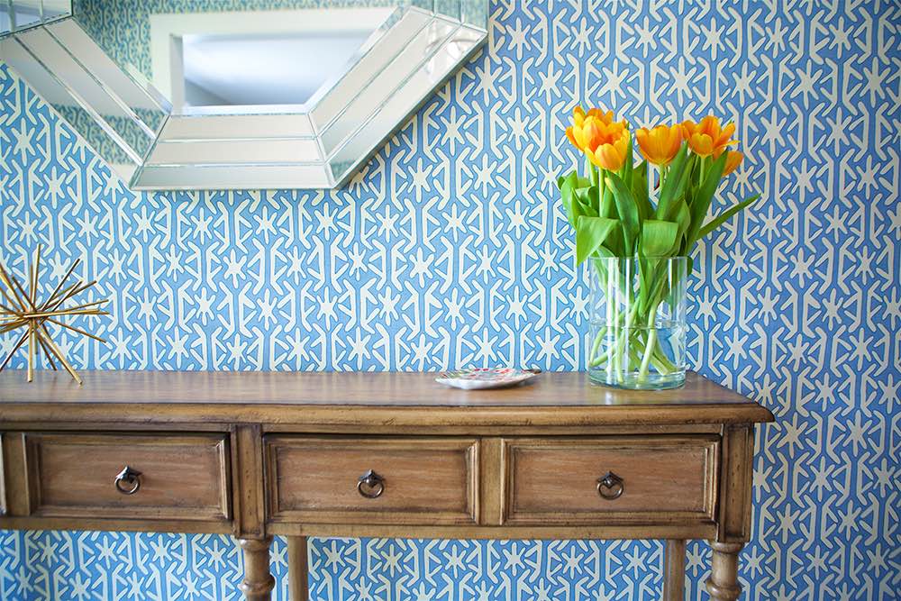 Blue and white wallpaper in bright entryway