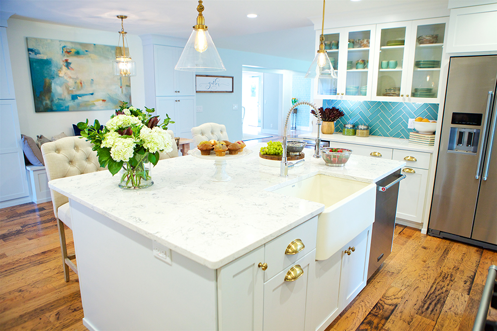 Kitchen island with gold hardware and farmhouse sink
