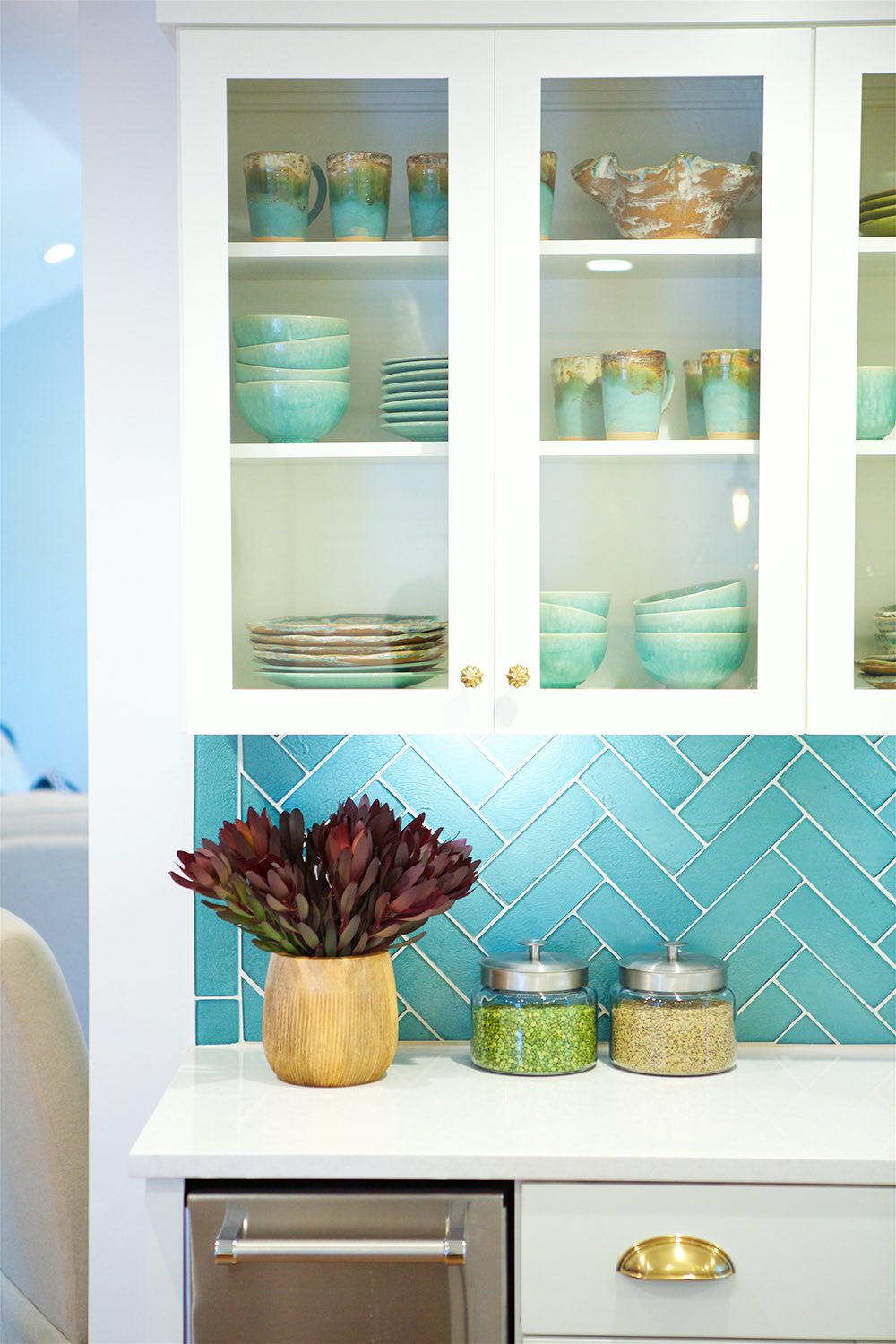 Turquoise dishware in open cabinets