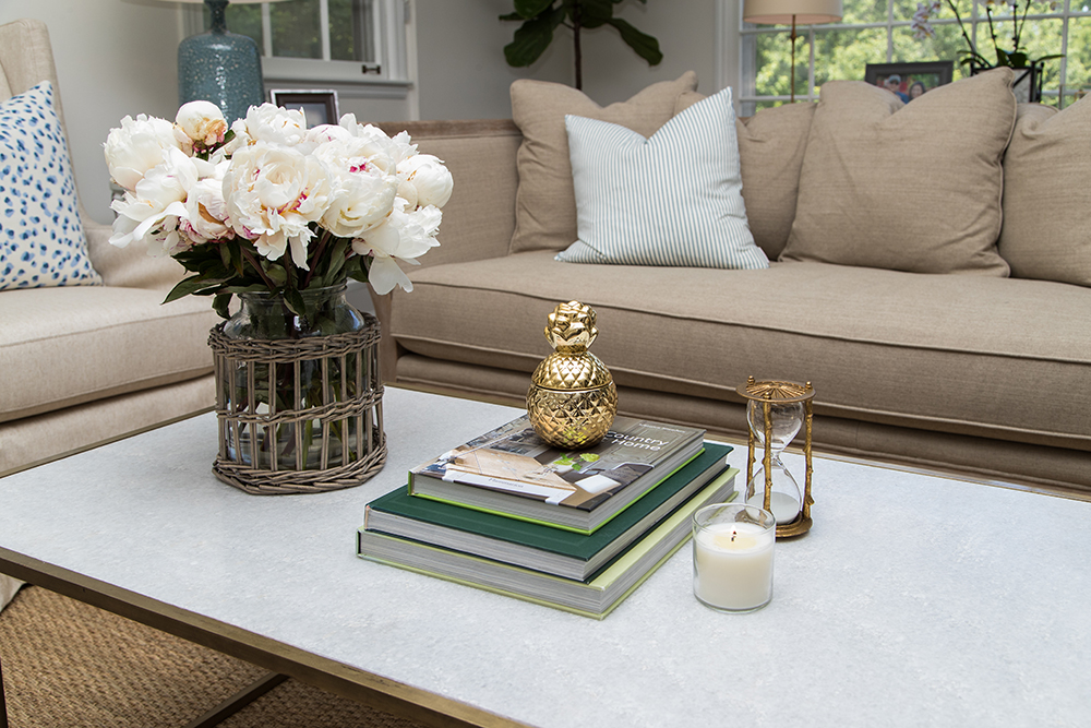Coffee table with gold pineapple decor and peonies