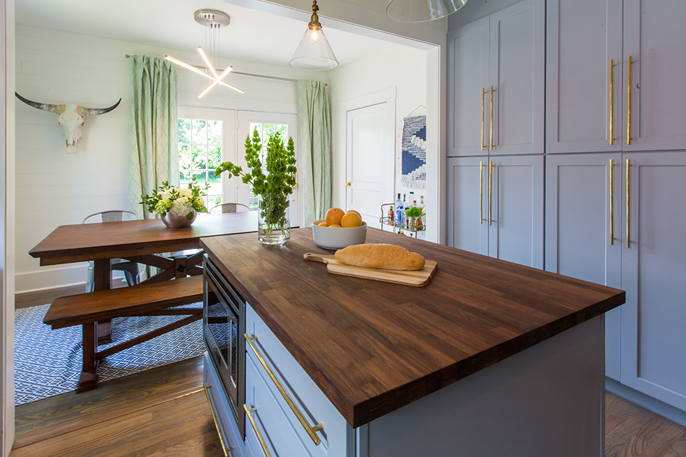 Blue kitchen built-ins with wood island