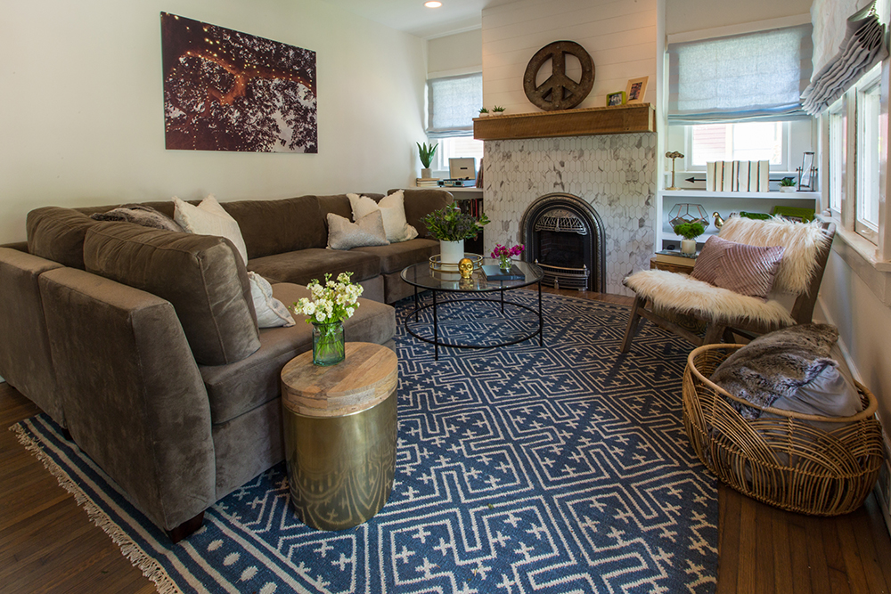 Living room with statement fireplace and blue rug