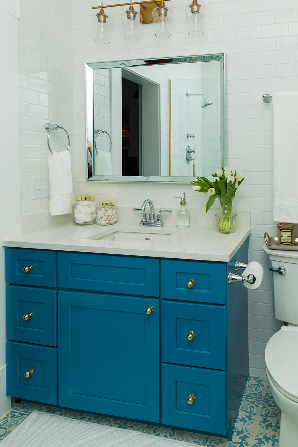 Blue bathroom vanity with gold knobs