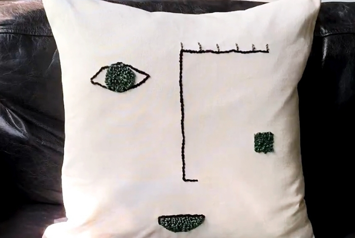 Abstract face punch needle pillow case